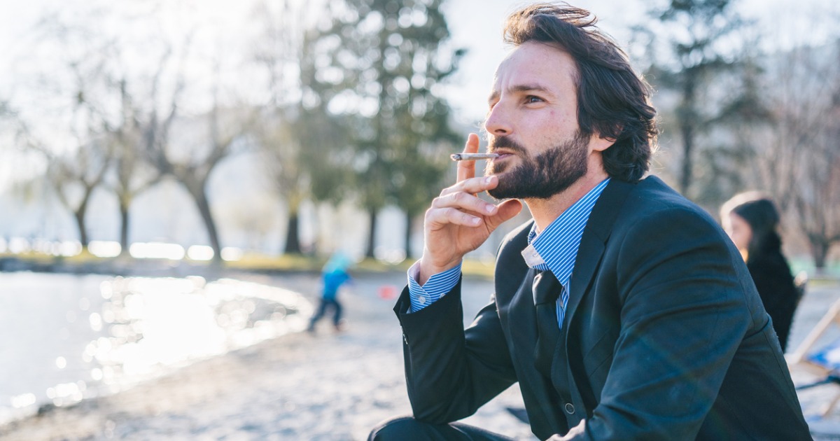 Businessman Smokes Joint by Lake